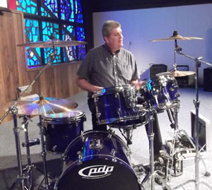 Calvary Evangelical Church Pastor Dale Bolenbaugh plays the drums for Calvary Preschool students (photo submitted)