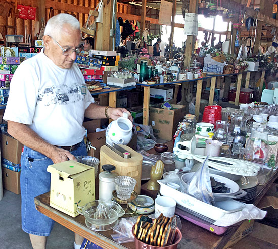 Volunteer Lloyd Marvin helps rearrange items for the Van Wert County Council on Aging's annual garage sale fundraiser, now under way at the Senior Center on Fox Road. (Cindy Wood/Van Wert independent)