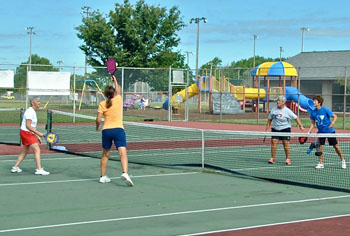 Four avid pickleball players enjoy a morning at the Smiley Park courts. (photo by Jim Cox)