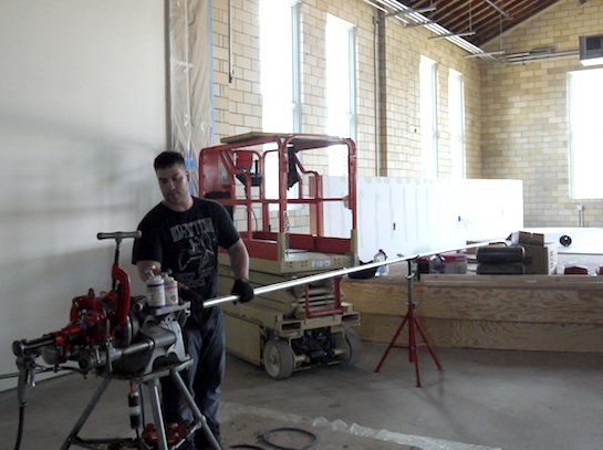 Josh Bly of Armor Sprinkling Systems of Lima saws another pipe to fit. (Photo submitted.)