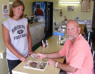 Local businessman Brett Thatcher of Thatcher Insurance Agency has been purchasing his annual county fair season tickets from The Sportsman for many years. It is a family tradition started by his father, Harvey Thatcher. Cindy Dawson of The Sportsman prepares Thatcher’s tickets for the 157th Van Wert County Fair after his recent visit for a quick lunch. (photo submitted)