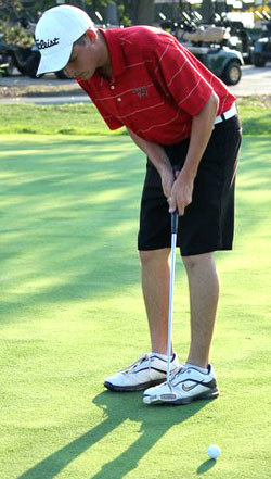 Cougar golfer Justin Price shows off his putting stroke against St. Marys. (photo submitted)
