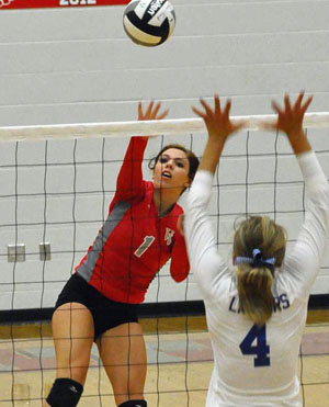 Cougar Cheyenne Handy (1) spikes over Lincolnview's Bayley Neate during Tuesday night's non-league volleyball match. (Jan Dunlap/Van Wert independent)