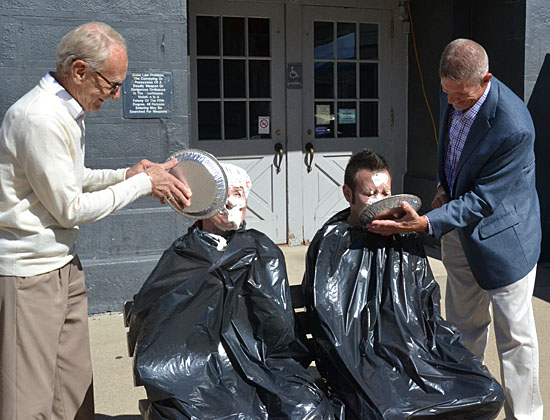Dawn Cooper (seated left) and Eric Hurless get pies in the face from, respectively, Van Wert Mayor Don Farmer and County Commissioner Thad Lichtensteiger. (Dave Mosier/Van Wert independent)