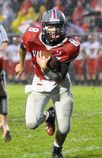 Van Wert quarterback Colin Smith (8) looks for running room Friday against the Kenton Wildcats. The Cougars couldn't generate much offense in the mud, losing 32-0 in the WBL contest. (Jan Dunlap/Van Wert independent)