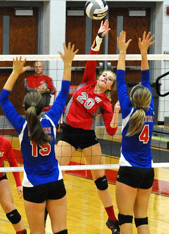 Van Wert's Alexa Dunlap (20) attempts to smash the ball over the net, while Lady Knights Grace Callow (15) and Claire Zaleski (4) try to block the shot. (Jan Dunlap/Van Wert independent)