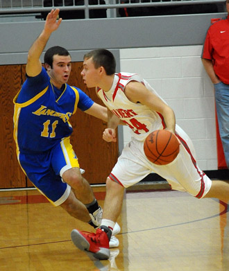 Van Wert's Connor Holliday (24) brings the ball down while guarded by Lancer Kyle Williams (11). The Cougars edged Lincolnview 46-41 in the opening game of the Van Wert County Hospital Tip-Off Tourney. (Jan Dunlap/Van Wert independent)