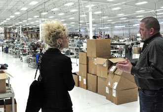 KAM Manufacturing owner Ollie Adams (right) gives Regional Economic Development Representative Chase Eikenbary some information on the local company. (photo submitted)