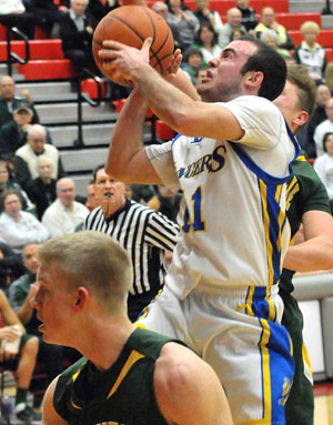 Lincolnview's Kyle Williams (11) goes up for a shot against Ottoville in the two teams' Division IV sectional tournament game on Tuesday. The Big Green won 70-66 in overtime. (Jan Dunlap/Van Wert independent)