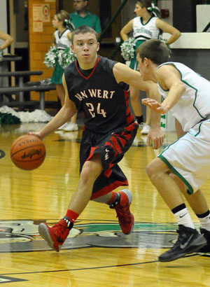 Cougar Connor Holliday (24) tries to drive around a Celina defender in a WBL contest won by the Bulldogs Friday night. (Jan Dunlap/Van Wert independent)