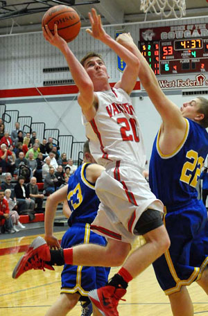 Kyle Keber (20) goes up for a layup against St. Marys during both team's regular season finale on Friday evening. The Cougars, who had four players in double figures, including Keber's 13-point performance, won the game. (Jan Dunlap/Van Wert independent)