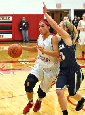 Van Wert's Alexis Dowdy (5) drives around a Napoleon defender during the Cougars' Division II sectional tournament game against the Wildcats on Saturday. (Jan Dunlap/Van Wert independent)
