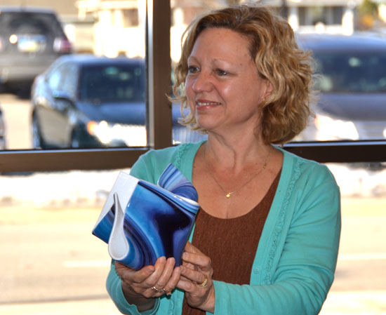 Retiring Crestview Treasurer Laura Metzger holds a piece of decorative glassware she was given as a farewell gift by the Crestview Local Board of Education. (Dave Mosier/Van Wert independent)