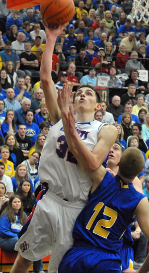 Tyson Bolenbaugh (32) goes up for a shot against Miller City during Friday night's Division IV district finals played at the Elida Fieldhouse. The Knights earned a berth in the regional tournament with a 54-39 win. (Jan Dunlap/Van Wert independent)