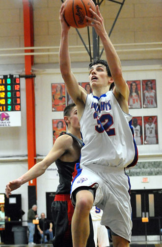 Crestview's Tyson Bolenbaugh (32) flies by a Columbus Grove defender for a layup during last night's Division IV district semifinal game won by the Knights. (Jan Dunlap/Van Wert independent)