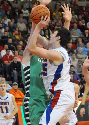 Crestview's Damian Helm (15) fights for a shot against an Ottawa Hills defender during the two teams' regional semifinal game at Bowling Green State University. The Knights won, 49-26. (Jan Dunlap/Van Wert independent)