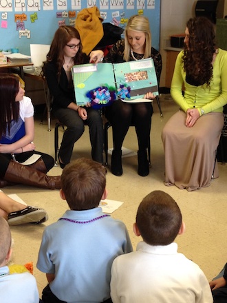 French students read books in French to first graders. (Photo submitted.)