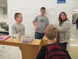 Austin Agler and Zach Dillon sell school supplies to students at the Lancer Supply stand that operates each morning as part of the sixth grade Math project. (Photo submitted.)