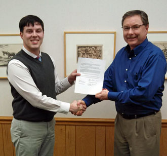 Van Wert County Foundation Executive Secretary Seth Baker (left) is shown formally accepting a new scholarship fund from Brian Etzler, president of the Van Wert County Fair Board. The Future Ag Leader Scholarship Fund will assist students pursing a degree in an agricultural field of study. (photo submitted)