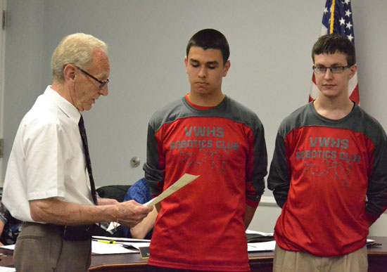 Van Wert Mayor Don Farmer reads a proclamation honoring the Van Wert High School Robotics Club while two members of the club look on. (Dave Mosier/Van Wert independent)