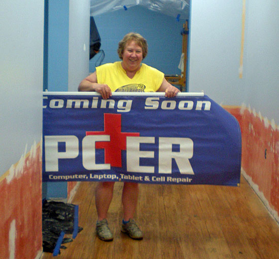 InterMedia3 owner Maggie Wannemacher holds the PC-ER sign that will be going up soon at a later retail establishment north of Van Wert. (photo submitted)