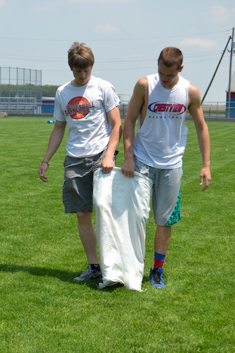 Seniors Brock Rolsten and Justin Gibson prepare for the three-legged race held on Tuesday’s high school fun day. The two went on to win the event for the senior class. (Photo submitted.)