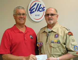 Shown are Elks Lodge Chaplain Larry Miller (left), and Greg Amstutz of the Black Swamp Council accepting the check.