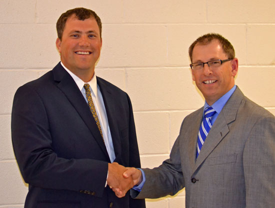 Lincolnview Superintendent Jeff Snyder (right) congratulates Brad Mendenhall after he was approved as the district's new high school-junior high school principal. (Dave Mosier/Van Wert independent)