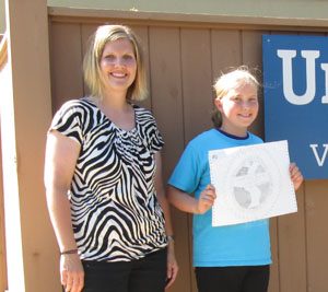 2014 Day of Caring Chair Jessi Hardesty (left) with drawing contest winner Brice Pruden. (United Way photo)