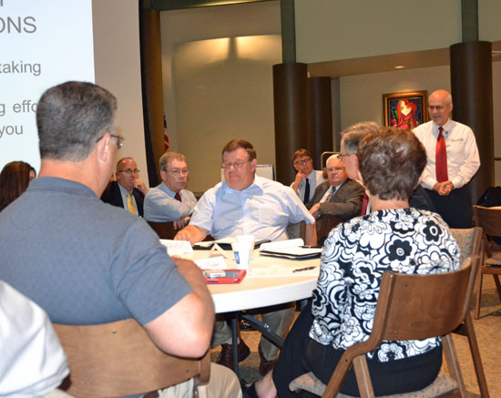 Northwest State Community College President Dr. Thomas Stuckey (standing) moderates a discussion on regional economic development issues during a summit held earlier this week at Northwest State in Archbold. (Dave Mosier/Van Wert independent)