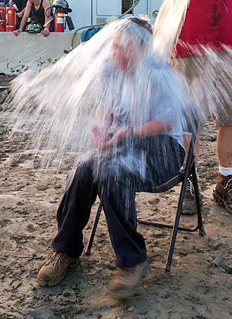 Dusty Figley dumps a bucket of ice water on Van Wert County Fair Board Director Sarah Smith during an ALS Ice Bucket Challenge Tuesday evening at the fairgrounds. (photo by Bob Barnes)