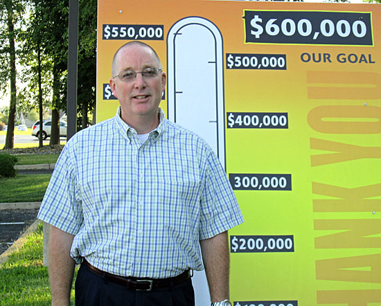 2014 United Way Campaign Chair Scott Mull poses with the thermometer showing this year's $600,000 goal. (photo submitted)