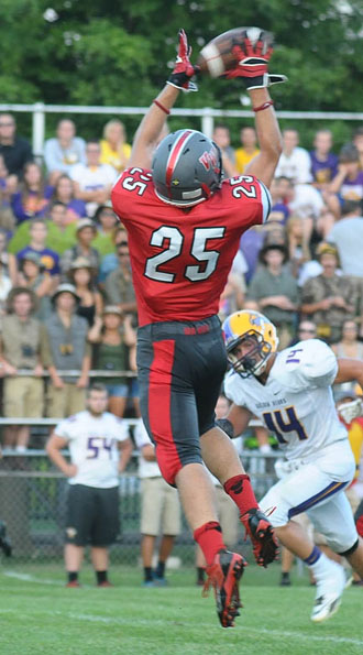 Van Wert's Nate Krugh (25) goes up for a catch that resulted in Van Wert's first touchdown Friday against the Bryan Golden Bears. Bryan edged the Cougars 18-14 in both team's grid opener. (Jan Dunlap/Van Wert independent)