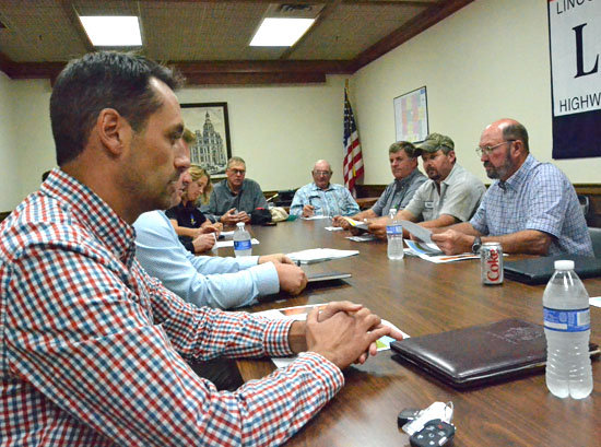 Apex Clean Energy representative John Arehart (left foreground) talks about a wind farm project in Van Wert County, while township trustees and county economic development people look on. (Dave Mosier/Van Wert independent)