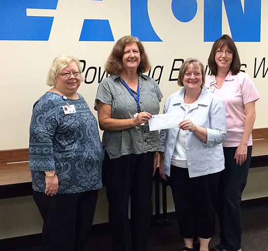Marcia Weldy (second from right) of Brumback Library, accepts a check from Eaton employees for the library's Enrichment Foundation (click here for more photos). (Dave Mosier/Van Wert independent)