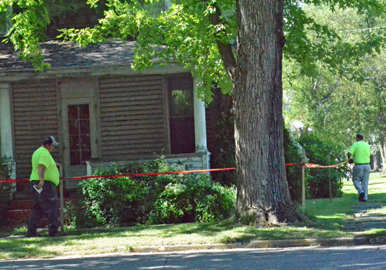 City workers put "danger" tape up around a dilapidated house located at the corner of Market and Second streets. (Dave Mosier/Van Wert independent)
