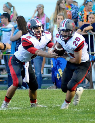 Van Wert quarterback Colin Smith (8) hands the ball off to Justice Tussing (20) during the Cougars' WBL opener against Ottawa-Glandorf. (Jan Dunlap/Van Wert independent)