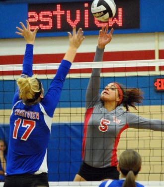 Alexis Dowdy (5) of Van Wert attempts to get the ball over Crestview's Courtney Trigg during Monday night's non-conference volleyball game won by the Knights. (Jan Dunlap/Van Wert independent)