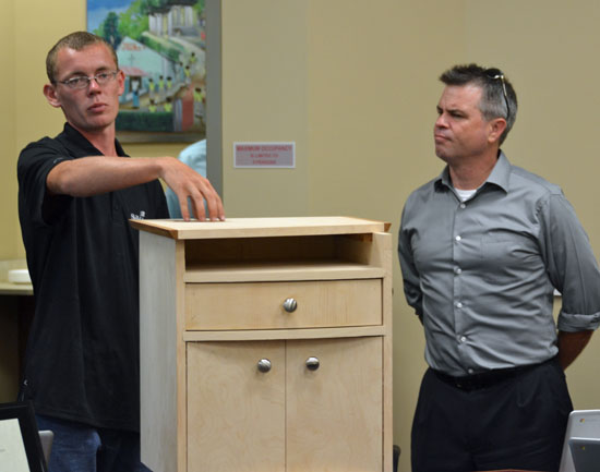 Vantage graduate Ben Schnipke shows off a cabinet he built during the SkillsUSA national competition held during the 2013-2014 school year, while Vantage Board member Pat Baumle looks on. (Dave Mosier/van Wert independent)