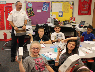 Van Wert Fire Chief Jim Steele with Van Wert Elementary School students holding their smoke detectors. (submitted photo)