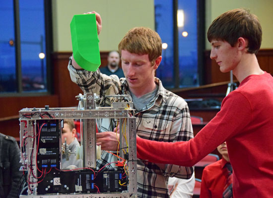 Van Wert High School Robotics Team members Ryan Rice (left) and Nick White show off one of the group's two new robots to the Van Wert City Board of Education. (Dave Mosier/Van Wert independent)