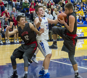 Lancer Chandler Adams (30) gets a hand on the ball to block a Columbus Grove player's shot, but the Bulldogs were able to get a slim win, 52-48, over Lincolnview. (Bob Barnes/Van Wert independent)