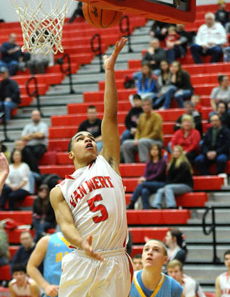 Van Wert's Jacoby Kelly (5) puts in a layup over two Bath defenders during a 57-47 WBL win for the Cougars. (Jan Dunlap/Van Wert independent)