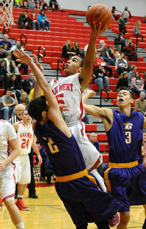 Cougar Jacoby Kelly (5) goes way up for a layup over a Bryan defender during Saturday's non-conference game won by Van Wert 57-38. (Jan Dunlap/Van Wert independent)