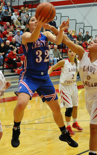 Crestview's Emily Bauer (32) goes up over Van Wert defender Alexis Dowdy (5) during a game won by the Knights, 44-27, in the Cougars' Den. (Jan Dunlap/Van Wert independent)