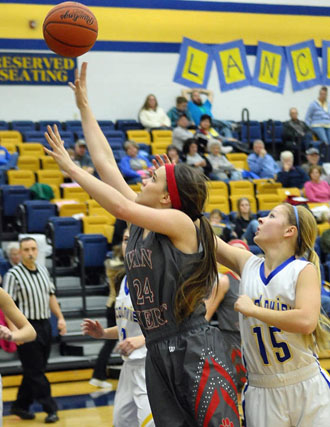 Van Wert's Erin Morrow (24) goes around defender Julia Thatcher (15) of Lincolnview to score during the Cougars' 55-41 win over the Lady Lancers. (Jan Dunlap/Van Wert independent)