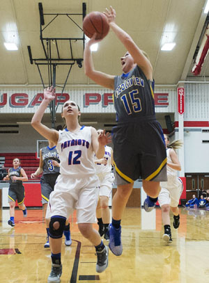 Lincolnview's Julia Thatcher (15) goes up for a layup over a Patrick Henry defender during the Lady Lancers' Division IV sectional win on Wednesday. (Bob Barnes/Van Wert independent)