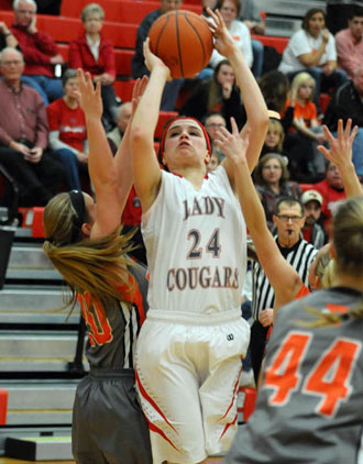 Cougar Erin Morrow (24) gets off a shot under heavy pressure during Van Wert's 51-44 win over the Bulldogs in Division II sectional action on Wednesday. (Jan Dunlap/Van Wert independent)