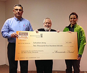 Shown are (from the left) Ron Schumm (winning farmer) Major Art Barter, and Shelby Anderson (Monsanto representative).