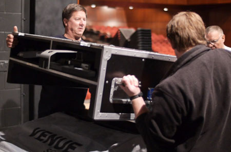 Van Wert Area Performing Arts Foundation Board member Chuck Koch (left) and another volunteer unload equipment at the Niswonger Performing Arts Center. (photo by Darin Hohman for the Van Wert independent)